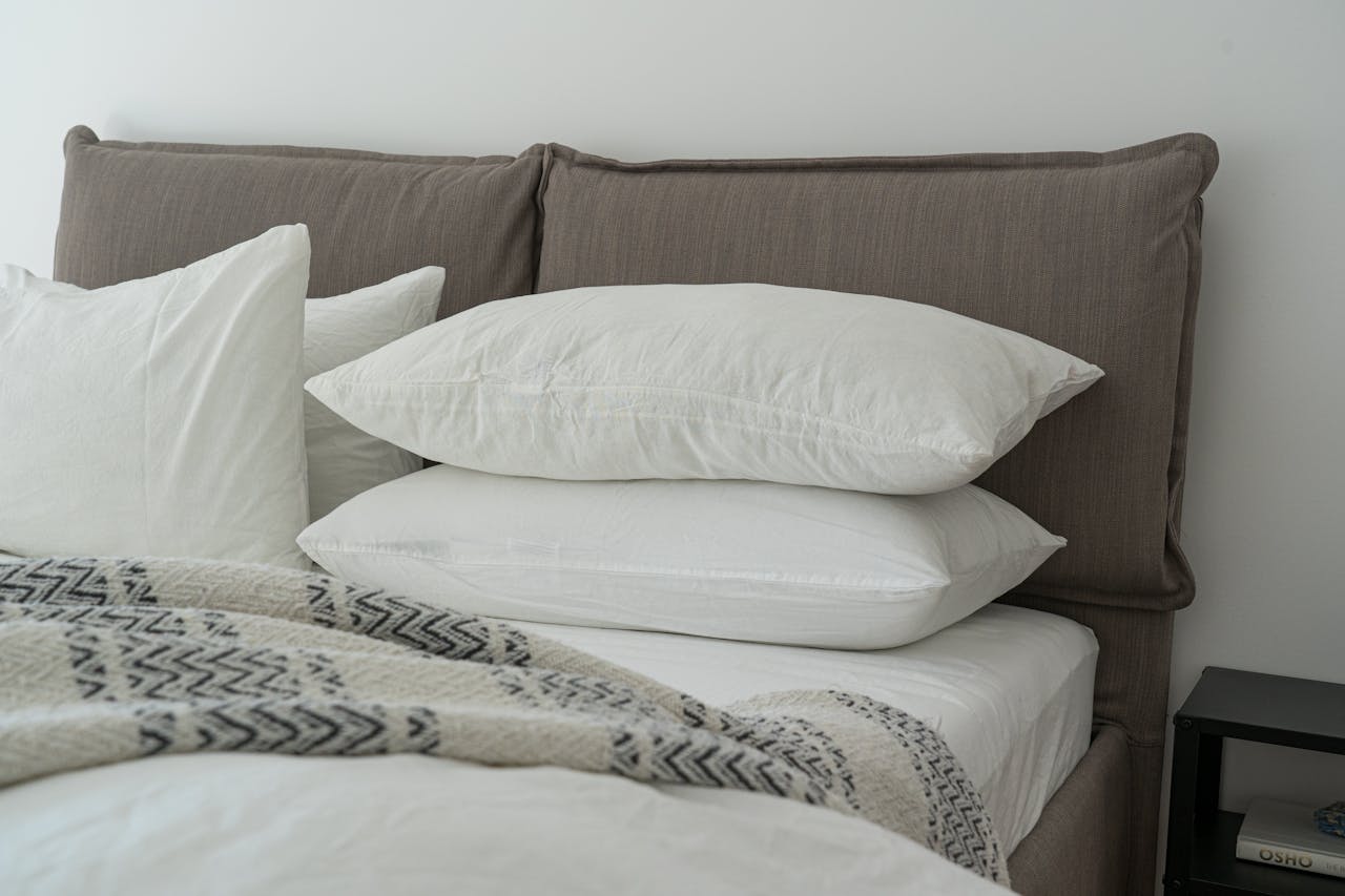 heros-img Modern bedroom featuring clean white bedding and pillows for a cozy and inviting atmosphere.
